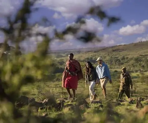Maasai community members in traditional dress welcoming visitors in Tanzania.