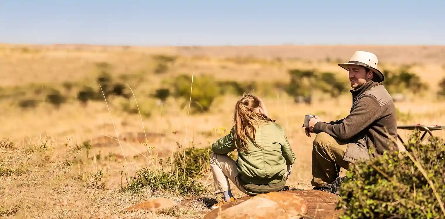 Responsible tourism in Tanzania, safari guide overlooking the savannah at sunset